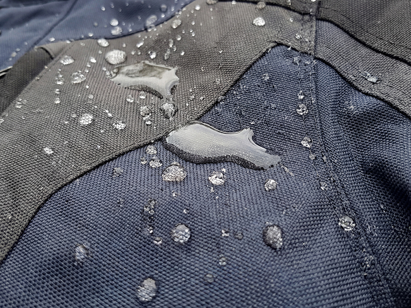 Motorcycle jacket with DWR treated fabric with beading water